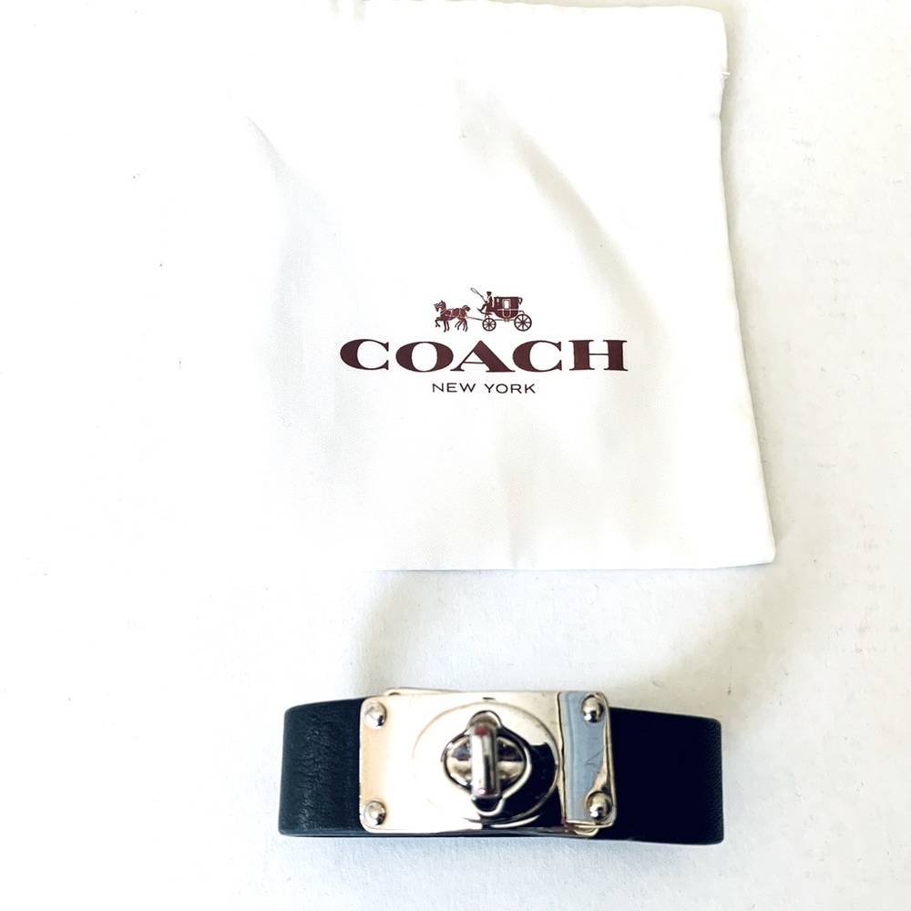 Coach black leather cuff bracelet with silver tone metal turnlock